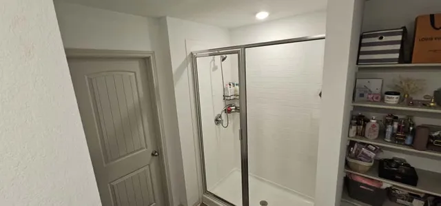 a bathroom with a shower and a sink