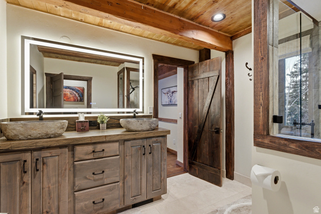 2687 Stewart Road Sundance, UT 84604 - Photo 40 of 48 Full bathroom with double vanity, a wood ceiling with exposed beams, light tile patterned floors, and recessed lighting