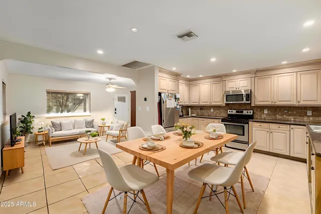 a large kitchen with a table and chairs