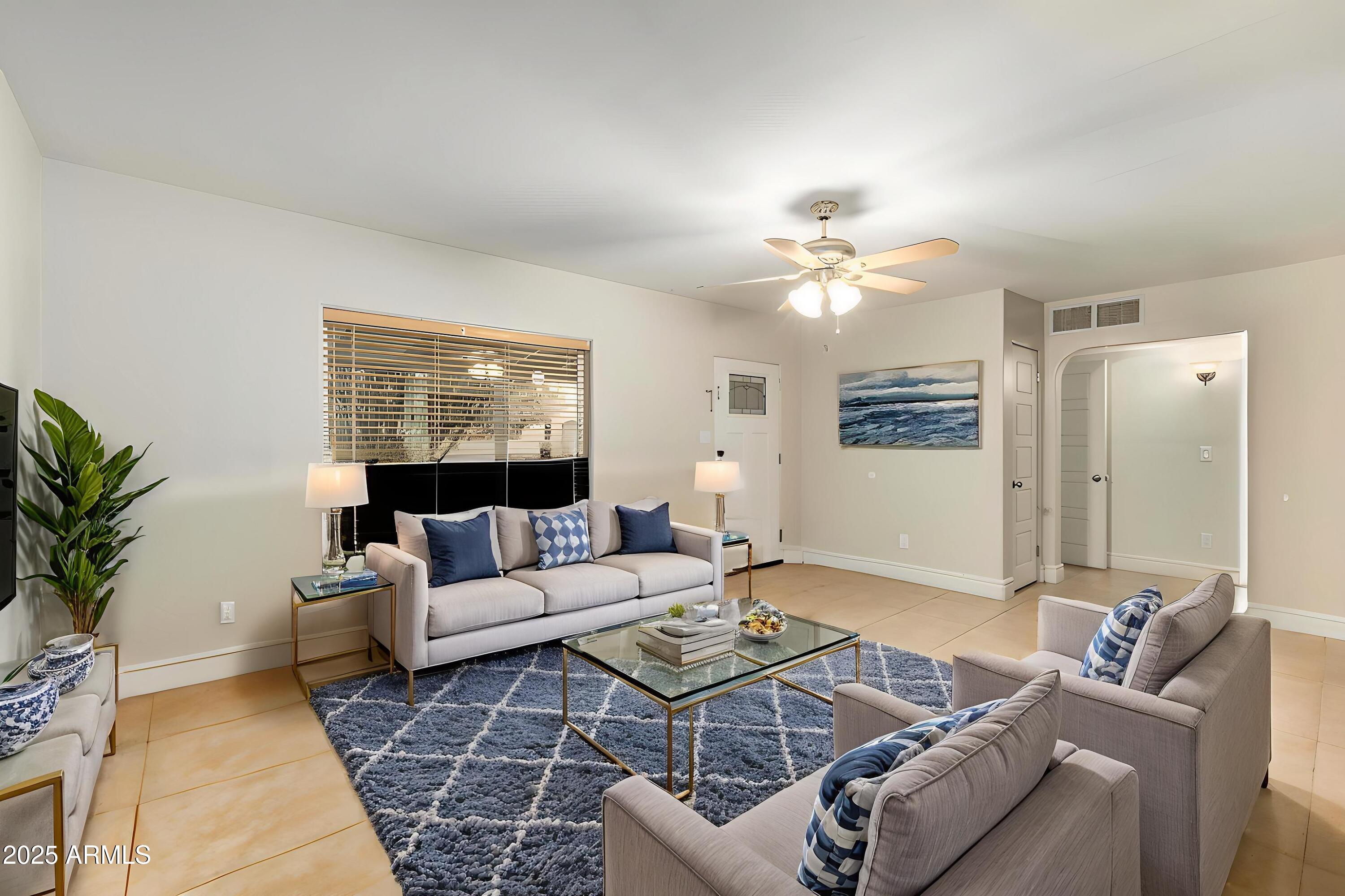 6842 North 10th Place Phoenix, AZ 85014 - Photo 13 of 60 a living room with furniture and a large window