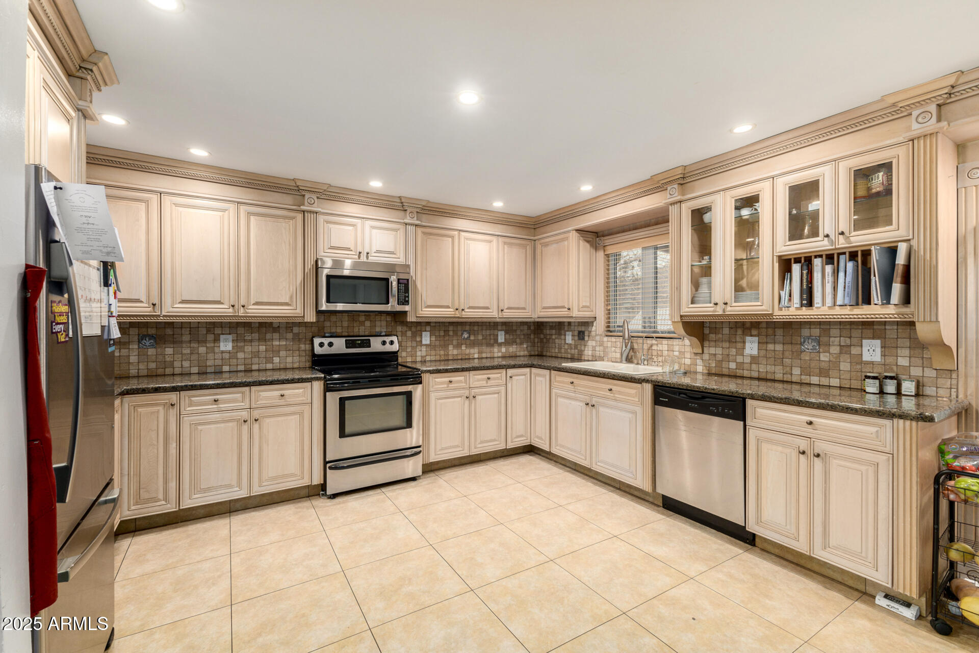 6842 North 10th Place Phoenix, AZ 85014 - Photo 15 of 60 a kitchen with granite countertop a stove top oven sink and cabinets
