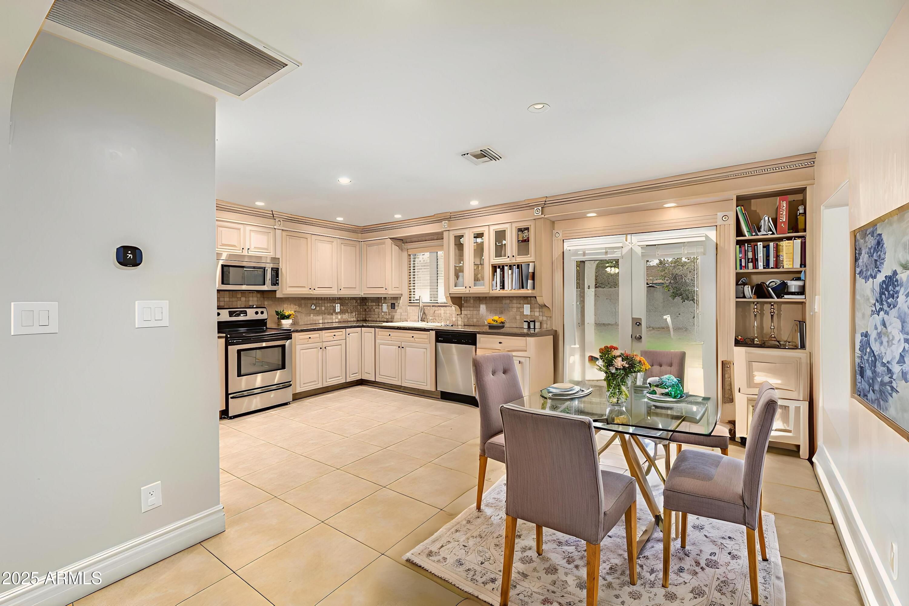 6842 North 10th Place Phoenix, AZ 85014 - Photo 18 of 60 a kitchen with stainless steel appliances kitchen island granite countertop a refrigerator and cabinets