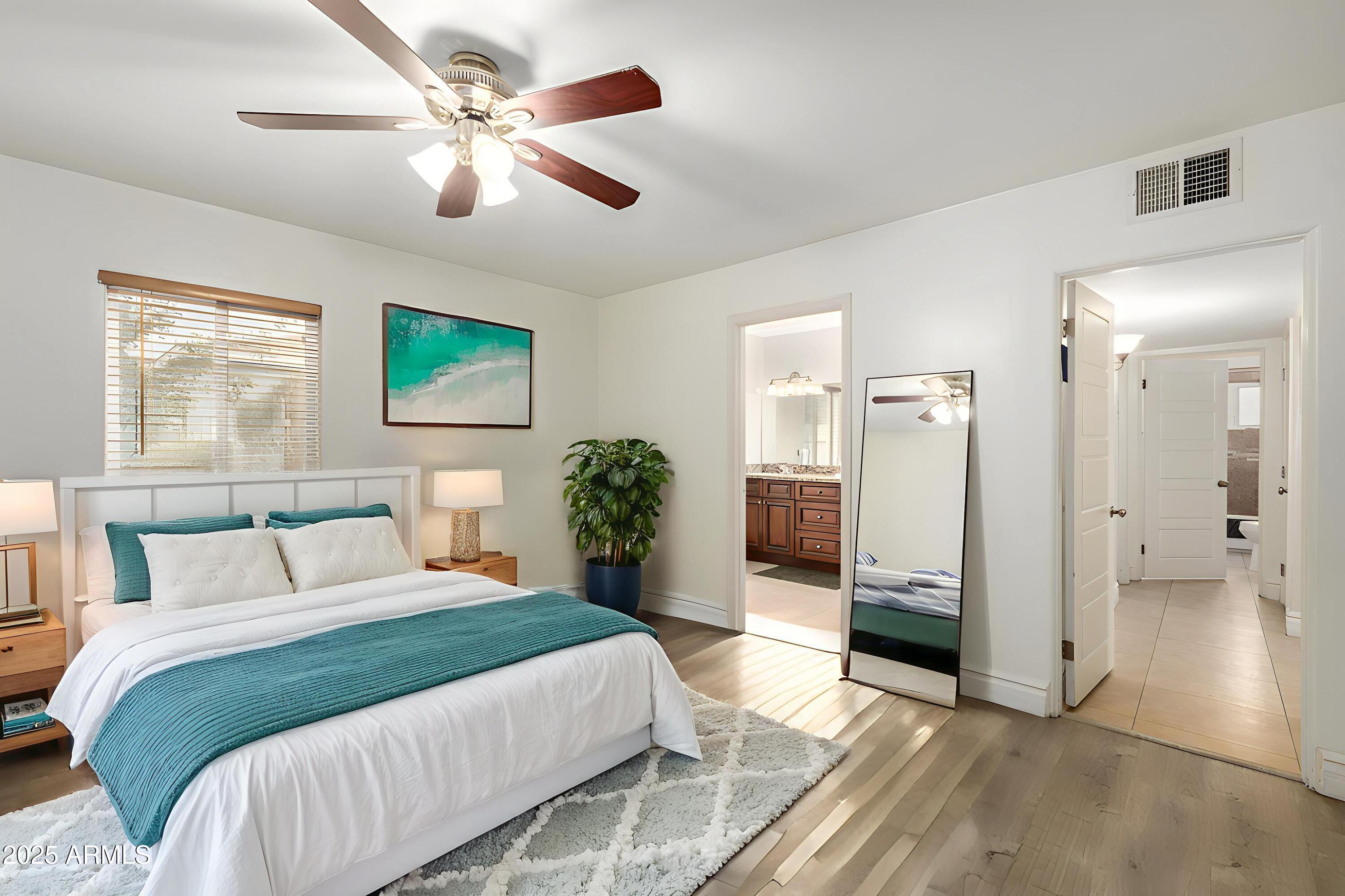 6842 North 10th Place Phoenix, AZ 85014 - Photo 21 of 60 a bedroom with a bed and a ceiling fan