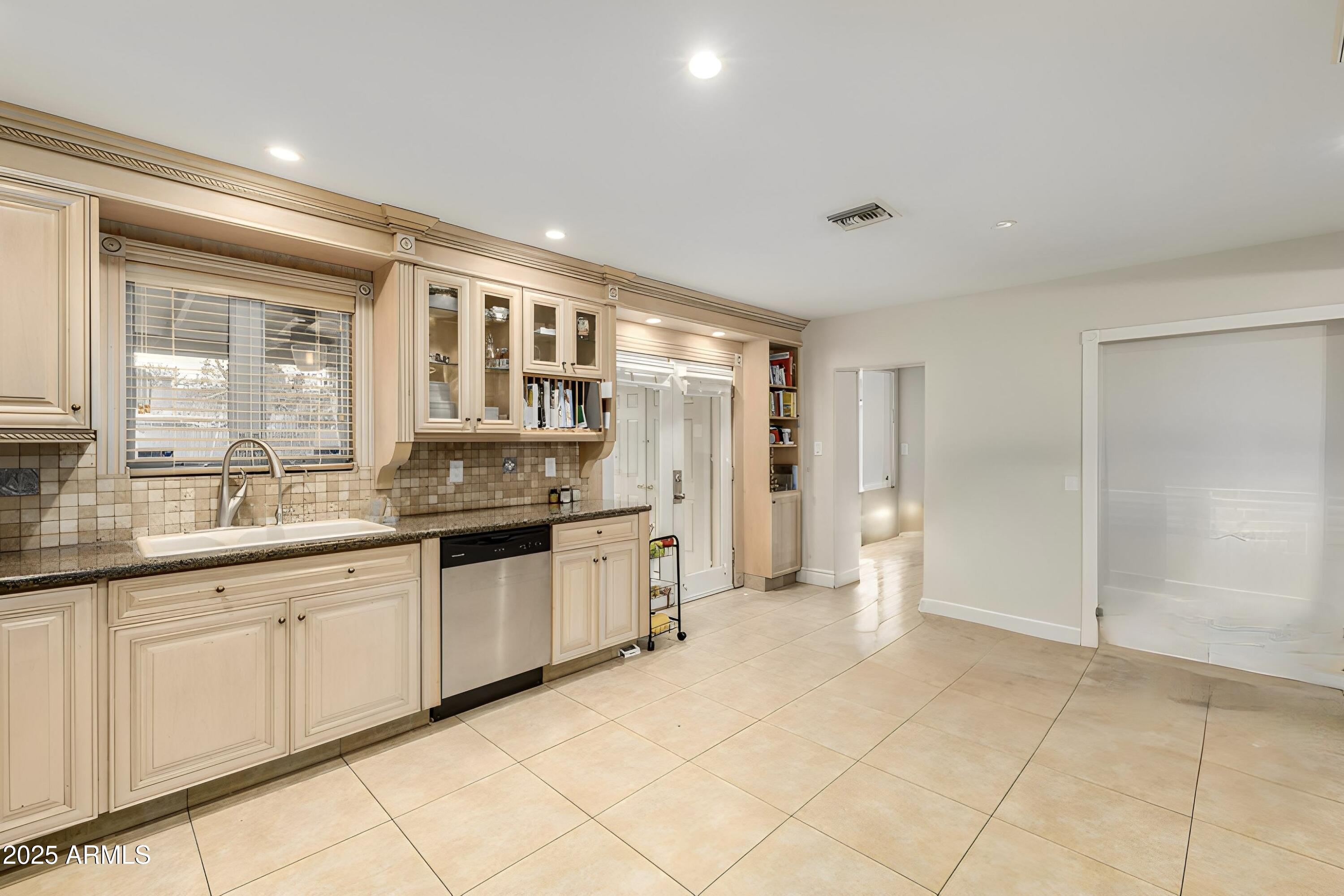6842 North 10th Place Phoenix, AZ 85014 - Photo 22 of 60 a kitchen with granite countertop a sink and cabinets