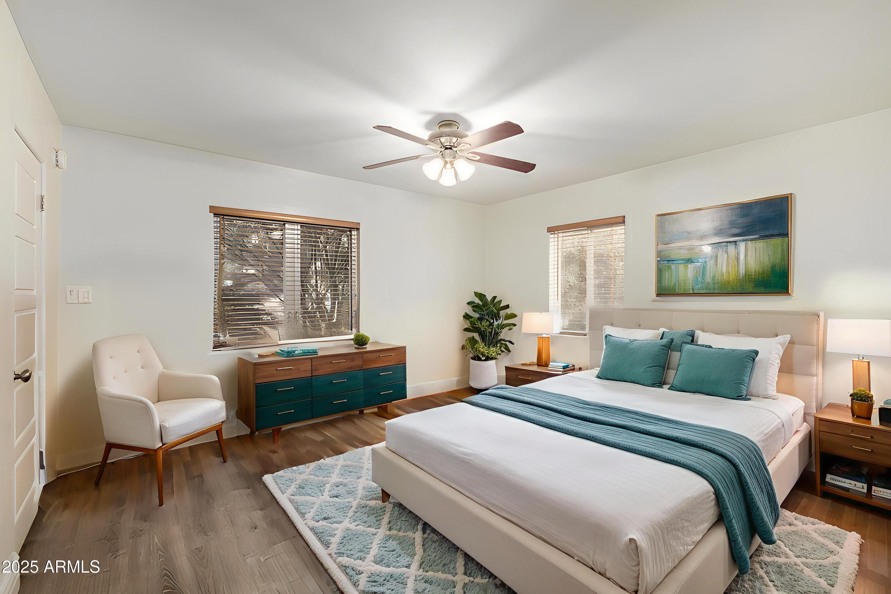 6842 North 10th Place Phoenix, AZ 85014 - Photo 23 of 60 a bedroom with a bed and a chandelier