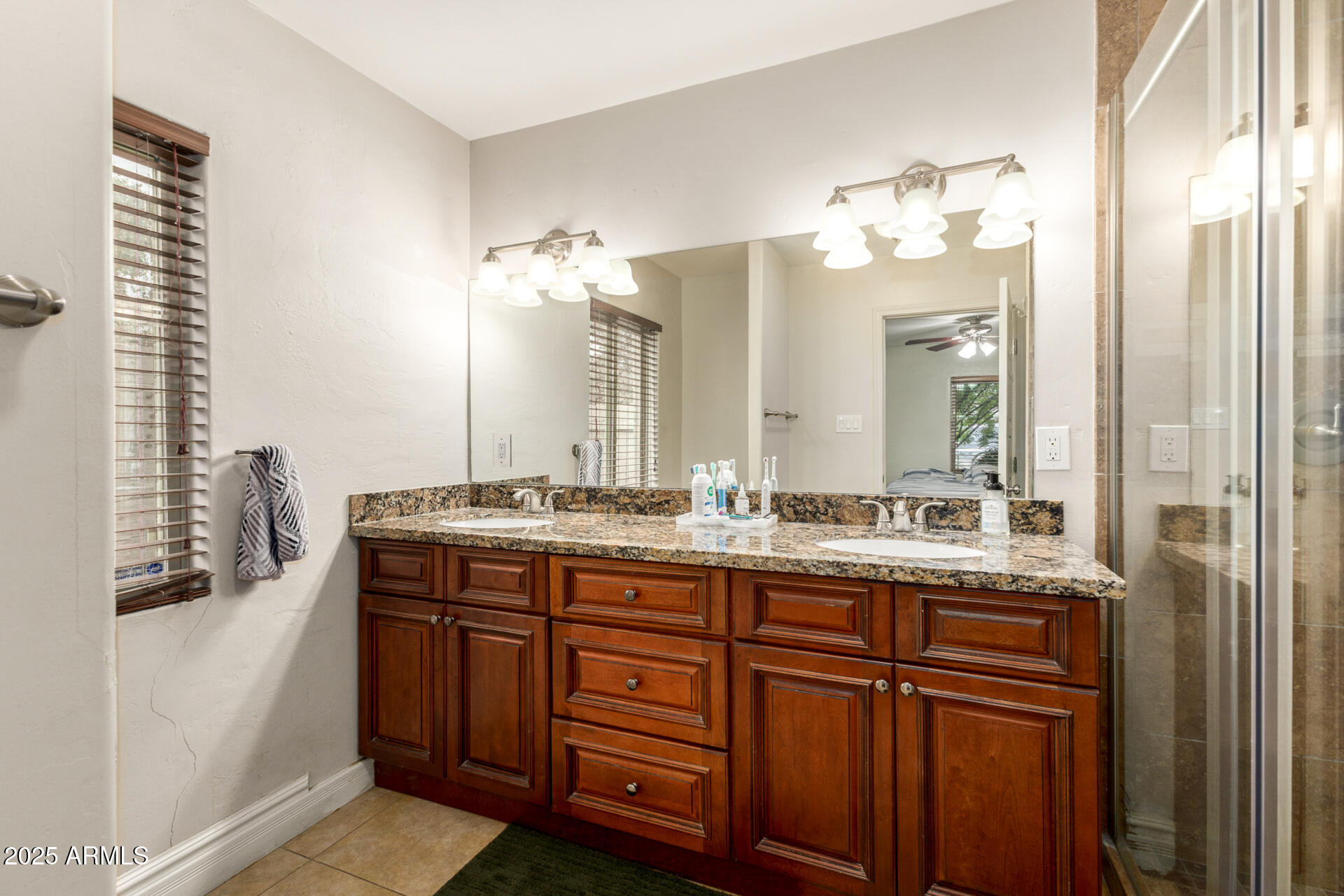 6842 North 10th Place Phoenix, AZ 85014 - Photo 26 of 60 a bathroom with a double vanity sink and a mirror