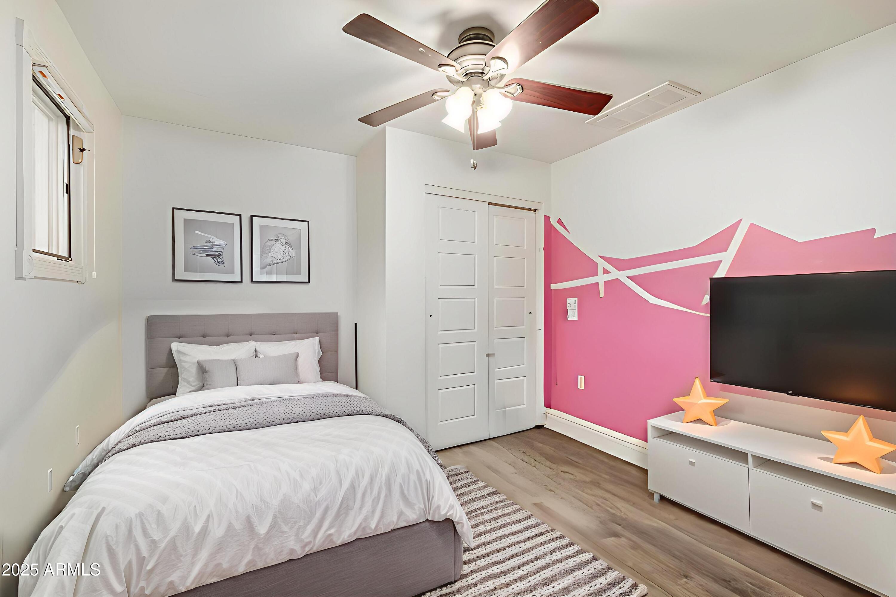 6842 North 10th Place Phoenix, AZ 85014 - Photo 30 of 60 a bedroom with a bed and a flat screen tv