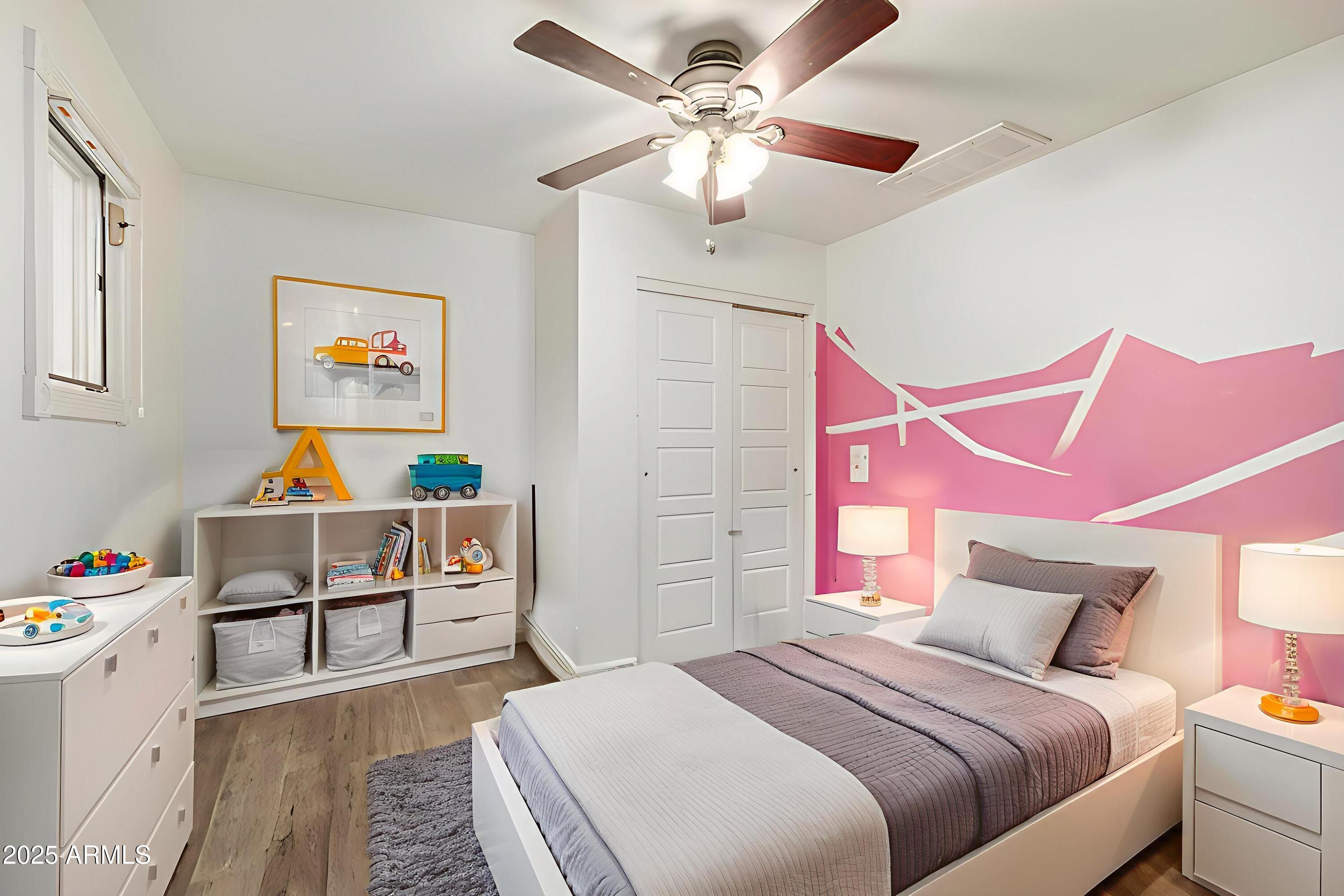 6842 North 10th Place Phoenix, AZ 85014 - Photo 34 of 60 a bedroom with a bed and a chandelier