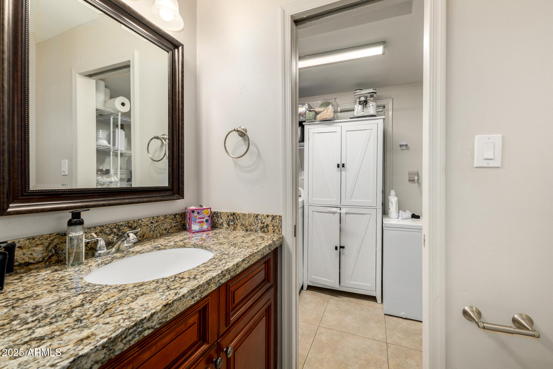 6842 North 10th Place Phoenix, AZ 85014 - Photo 35 of 60 a bathroom with a granite countertop sink and a mirror