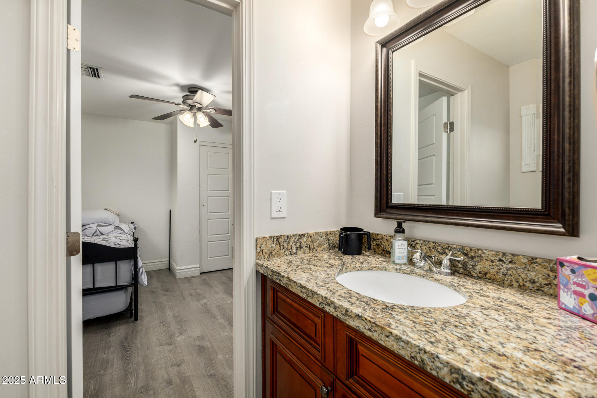 6842 North 10th Place Phoenix, AZ 85014 - Photo 36 of 60 a bathroom with a granite countertop sink and a mirror