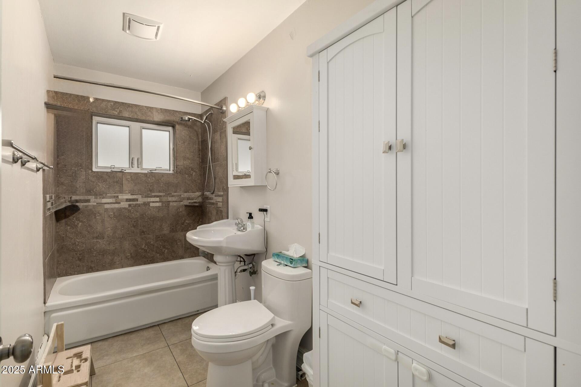 6842 North 10th Place Phoenix, AZ 85014 - Photo 37 of 60 a bathroom with a sink a toilet and shower