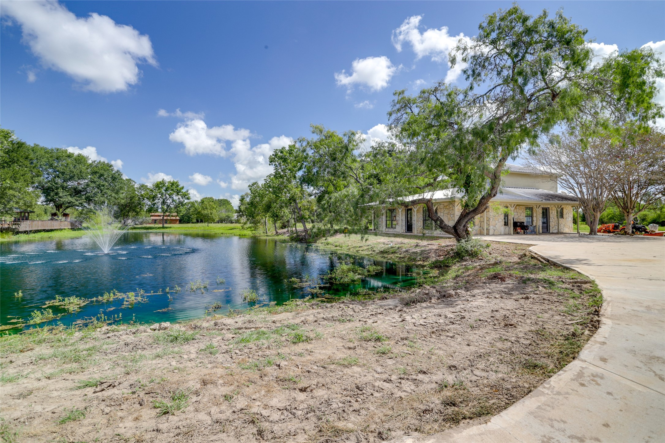 13302 Farm To Market 359, Unit A Hempstead, TX 77445 - Photo 2 of 28 a view of a lake with a house in the background