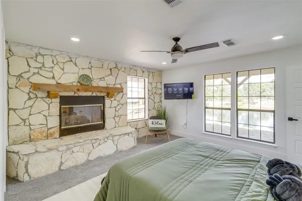 a bedroom with a bed and a fireplace