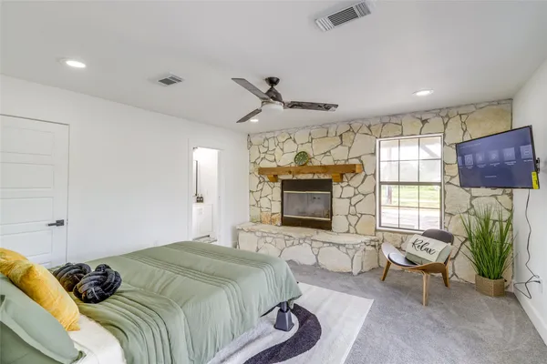 a bedroom with a bed couch and window
