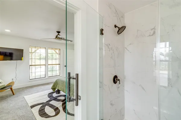 a bathroom with a window and a shower