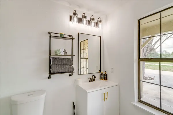 a bathroom with a sink a mirror and a window