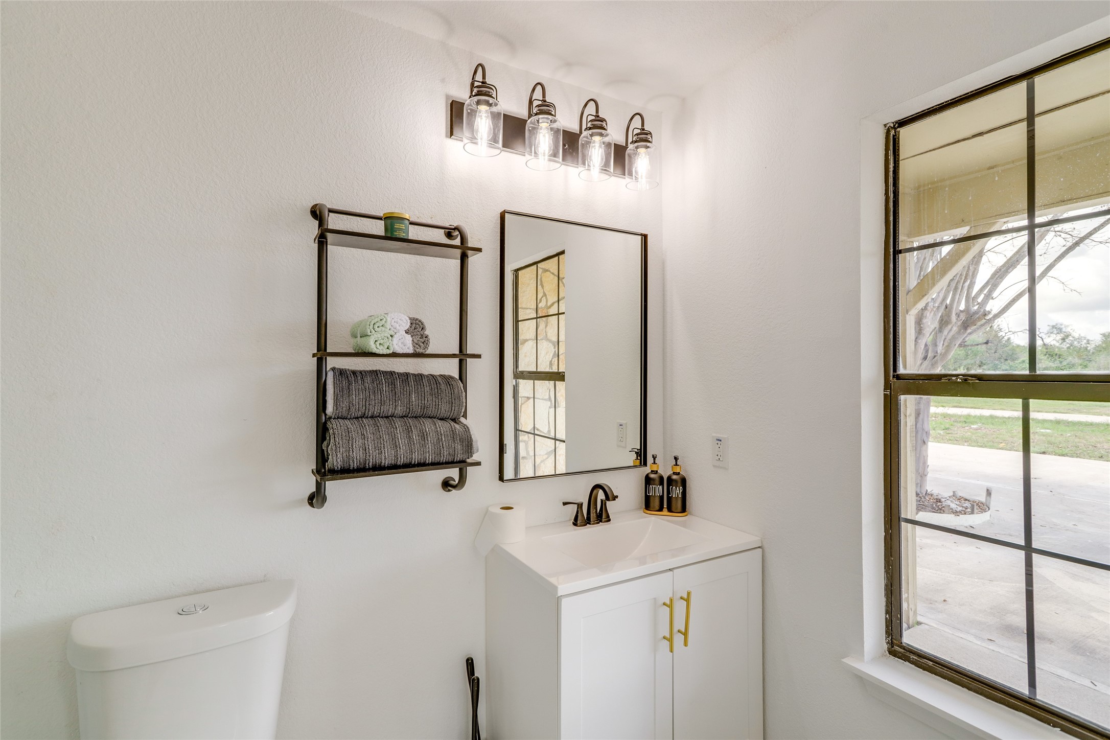 13302 Farm To Market 359, Unit A Hempstead, TX 77445 - Photo 26 of 28 a bathroom with a sink a mirror and a window