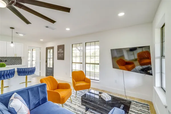 a living room with furniture and a flat screen tv