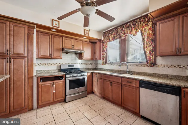 a kitchen with stainless steel appliances granite countertop a sink and cabinets