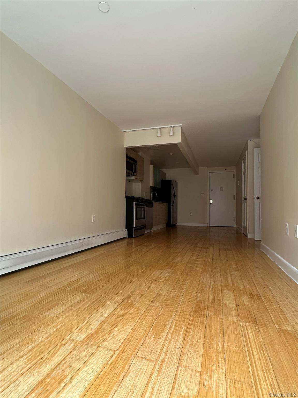 8375 117th Street, Unit 3B Queens, NY 11415 - Photo 3 of 7 a view of room with furniture and empty room