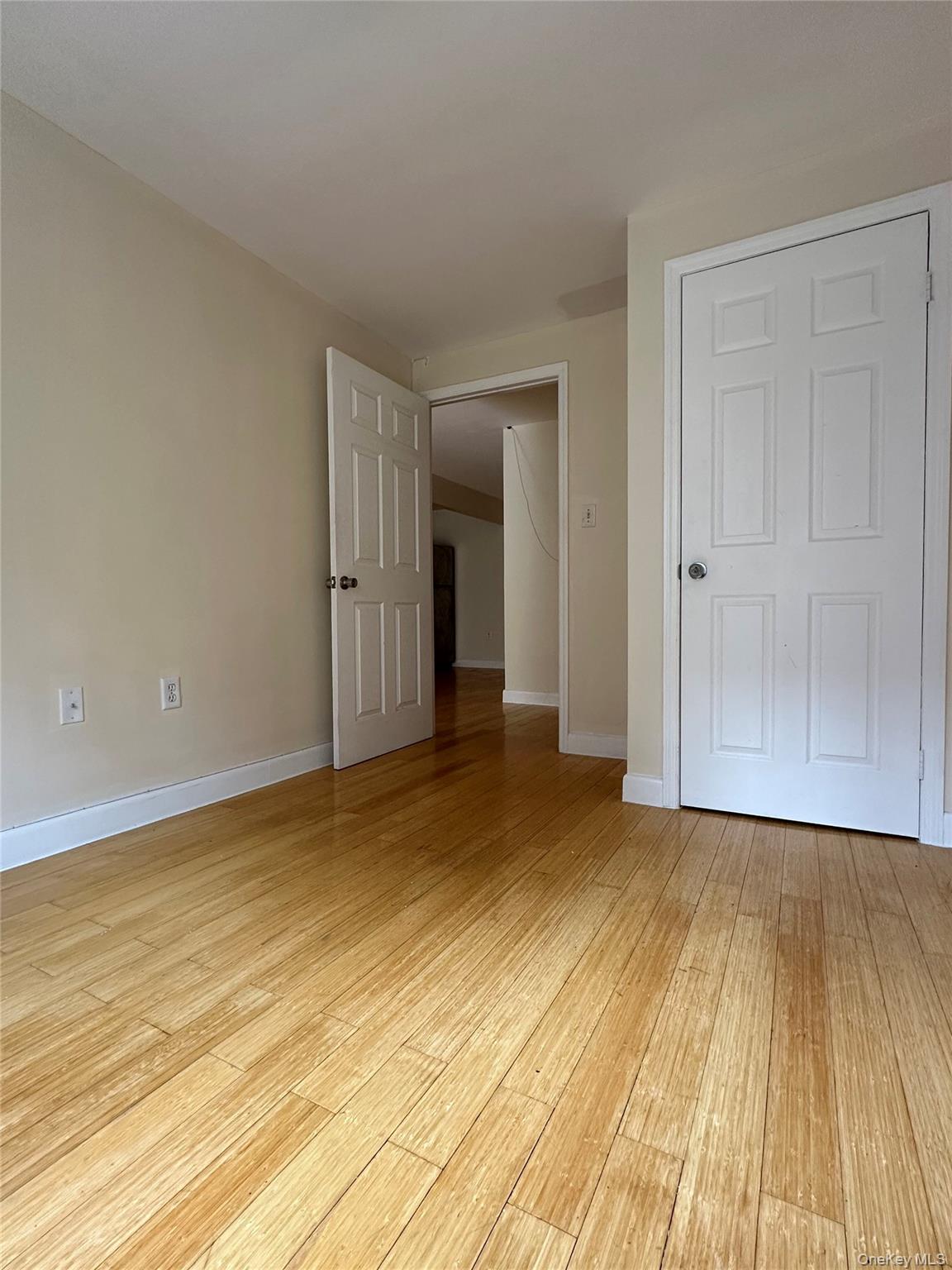 8375 117th Street, Unit 3B Queens, NY 11415 - Photo 4 of 7 a view of an empty room and wooden floor