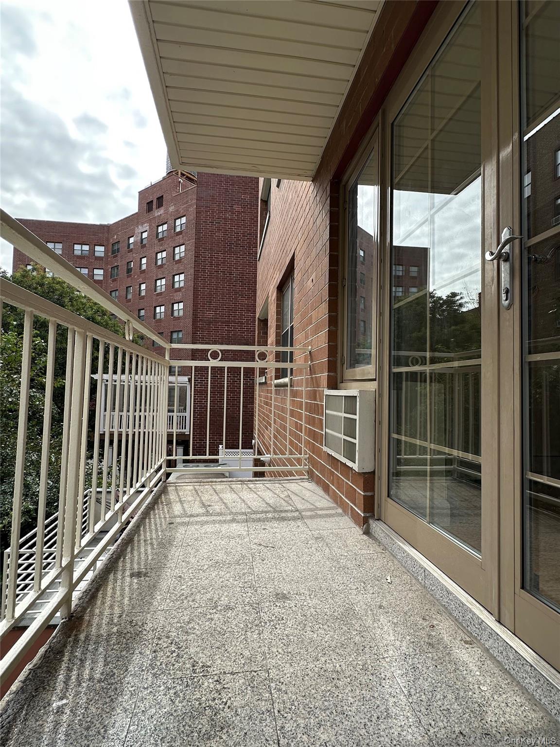 8375 117th Street, Unit 3B Queens, NY 11415 - Photo 6 of 7 a view of a porch with wooden floor and iron stairs