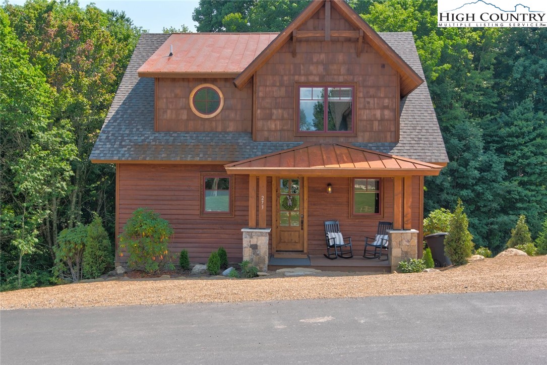 a front view of house with a garden
