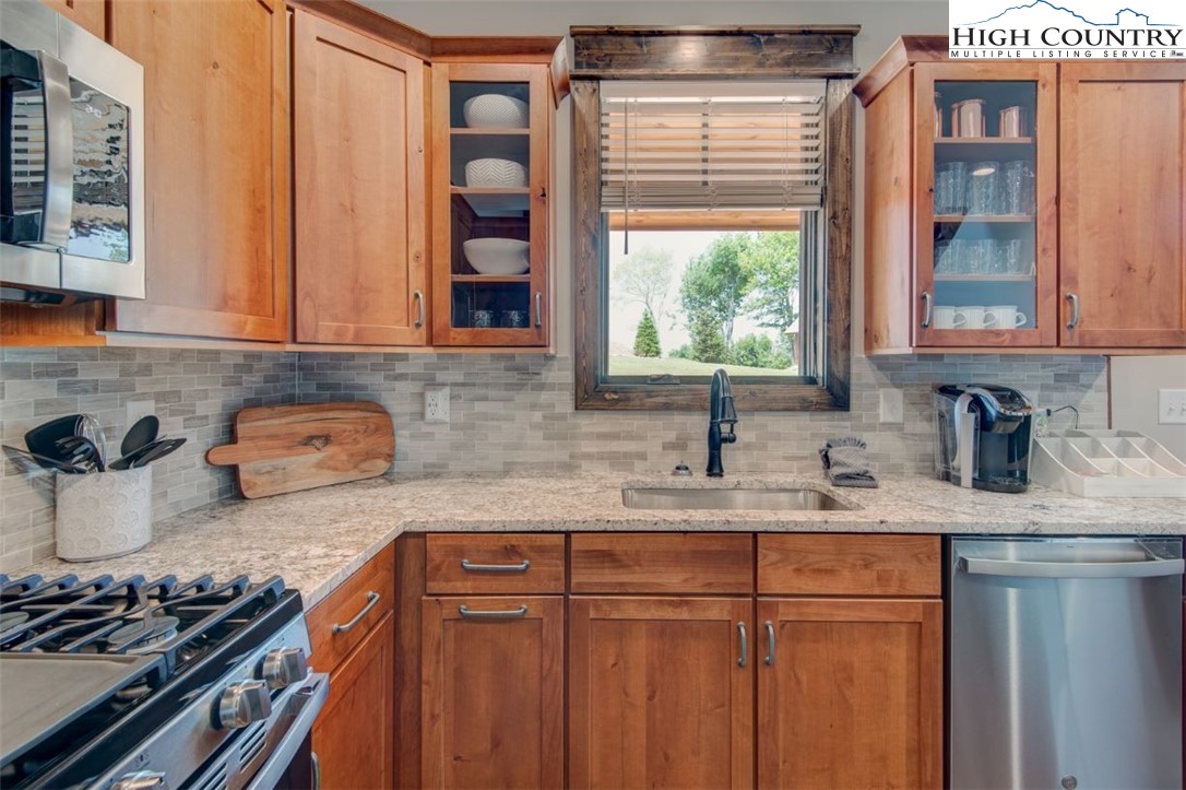 273 High Country Overlook Banner Elk, NC 28604 - Photo 12 of 50 a kitchen with stainless steel appliances granite countertop a sink stove and cabinets