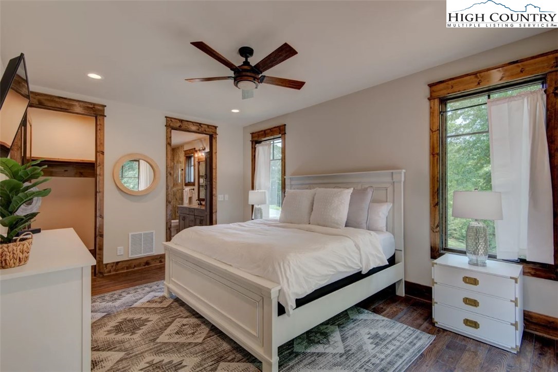 273 High Country Overlook Banner Elk, NC 28604 - Photo 13 of 50 a bedroom with a bed a chandelier and dresser