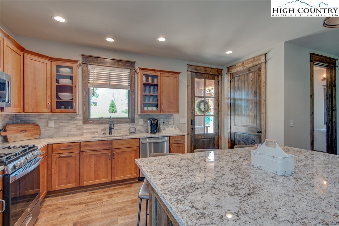 273 High Country Overlook Banner Elk, NC 28604 - Photo 26 of 50 a large kitchen with kitchen island a sink stainless steel appliances and cabinets