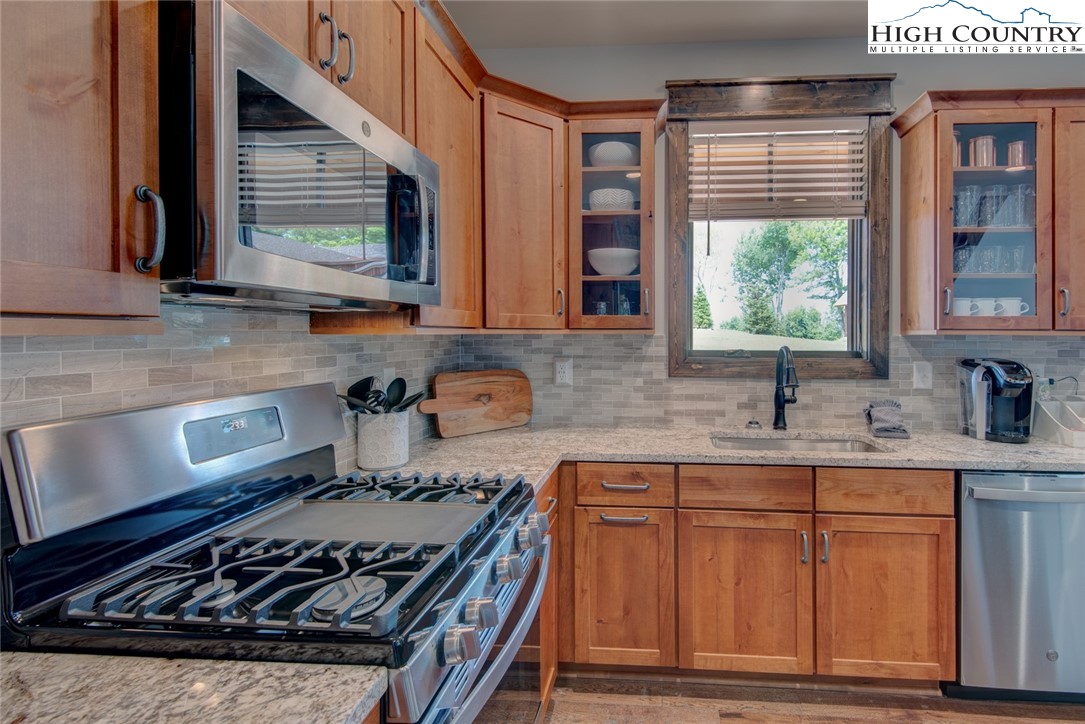 273 High Country Overlook Banner Elk, NC 28604 - Photo 27 of 50 a kitchen with granite countertop a stove a sink and a cabinets