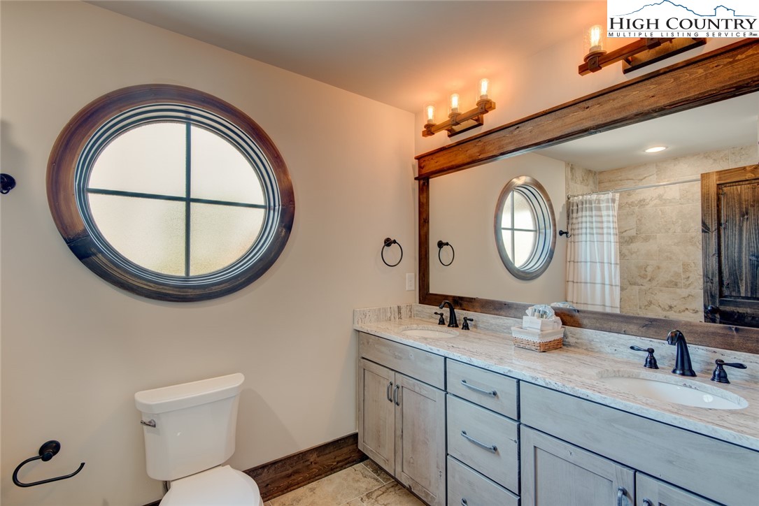 273 High Country Overlook Banner Elk, NC 28604 - Photo 35 of 50 a bathroom with a toilet a sink and a mirror