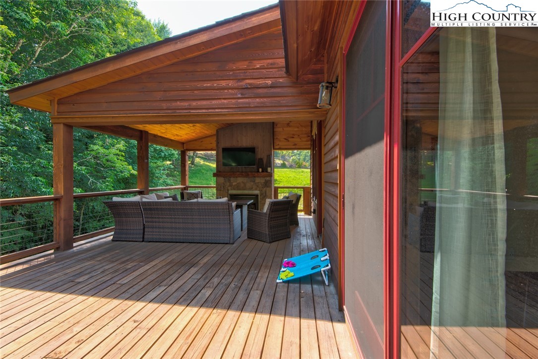 273 High Country Overlook Banner Elk, NC 28604 - Photo 38 of 50 a view of balcony with wooden floor and outdoor seating
