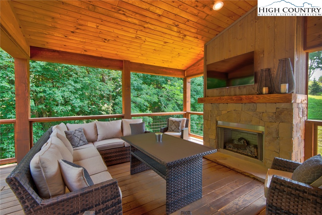 273 High Country Overlook Banner Elk, NC 28604 - Photo 39 of 50 a balcony with furniture and a fireplace