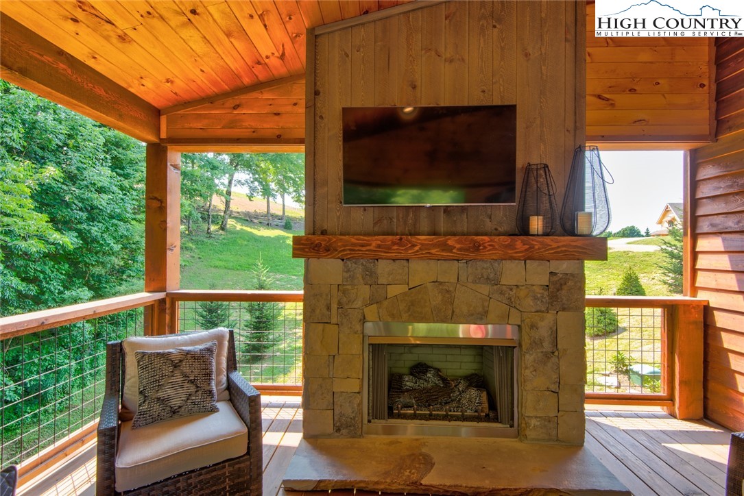 273 High Country Overlook Banner Elk, NC 28604 - Photo 42 of 50 a living room with a fireplace and a flat screen tv