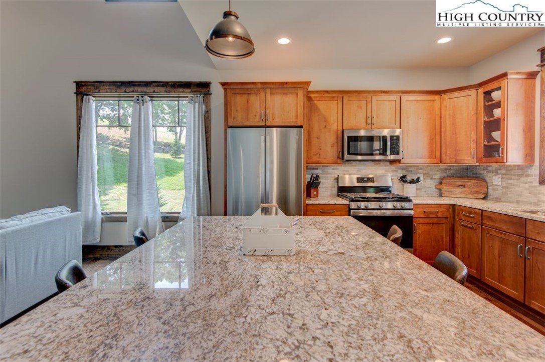 273 High Country Overlook Banner Elk, NC 28604 - Photo 8 of 50 a kitchen with stainless steel appliances a refrigerator stove microwave and sink