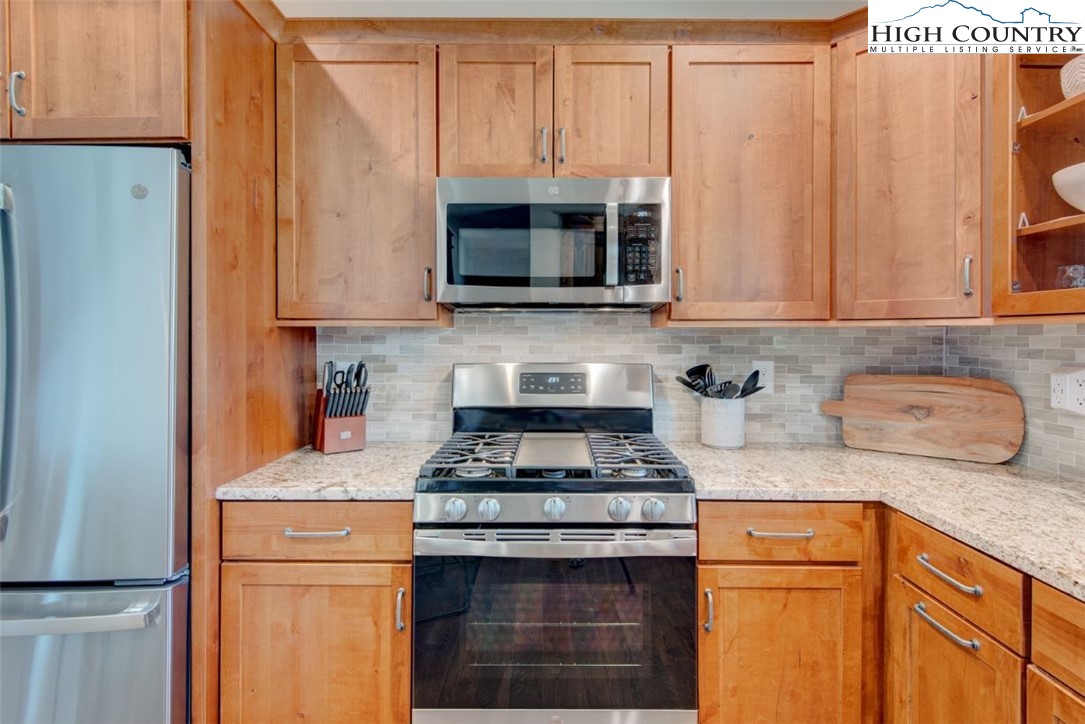 273 High Country Overlook Banner Elk, NC 28604 - Photo 9 of 50 a kitchen with granite countertop cabinets stainless steel appliances and a sink