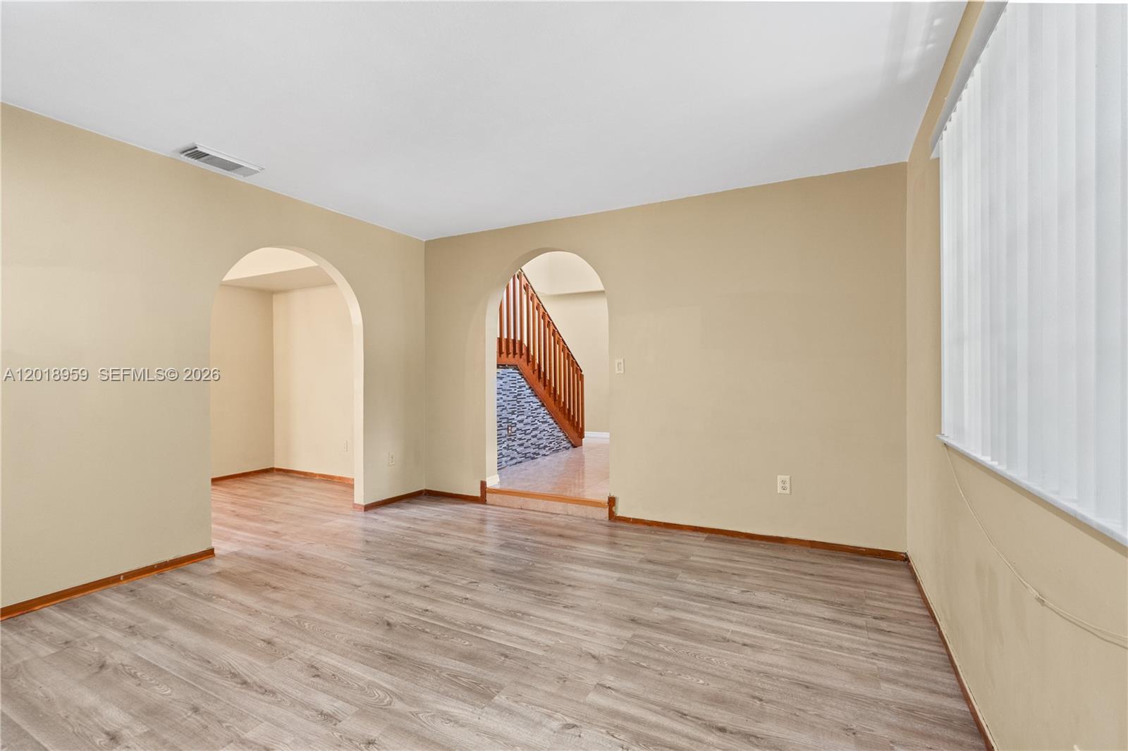 15345 Southwest 63rd Terrace Miami, FL 33193 - Photo 37 of 51 a view of an empty room with wooden floor and a window