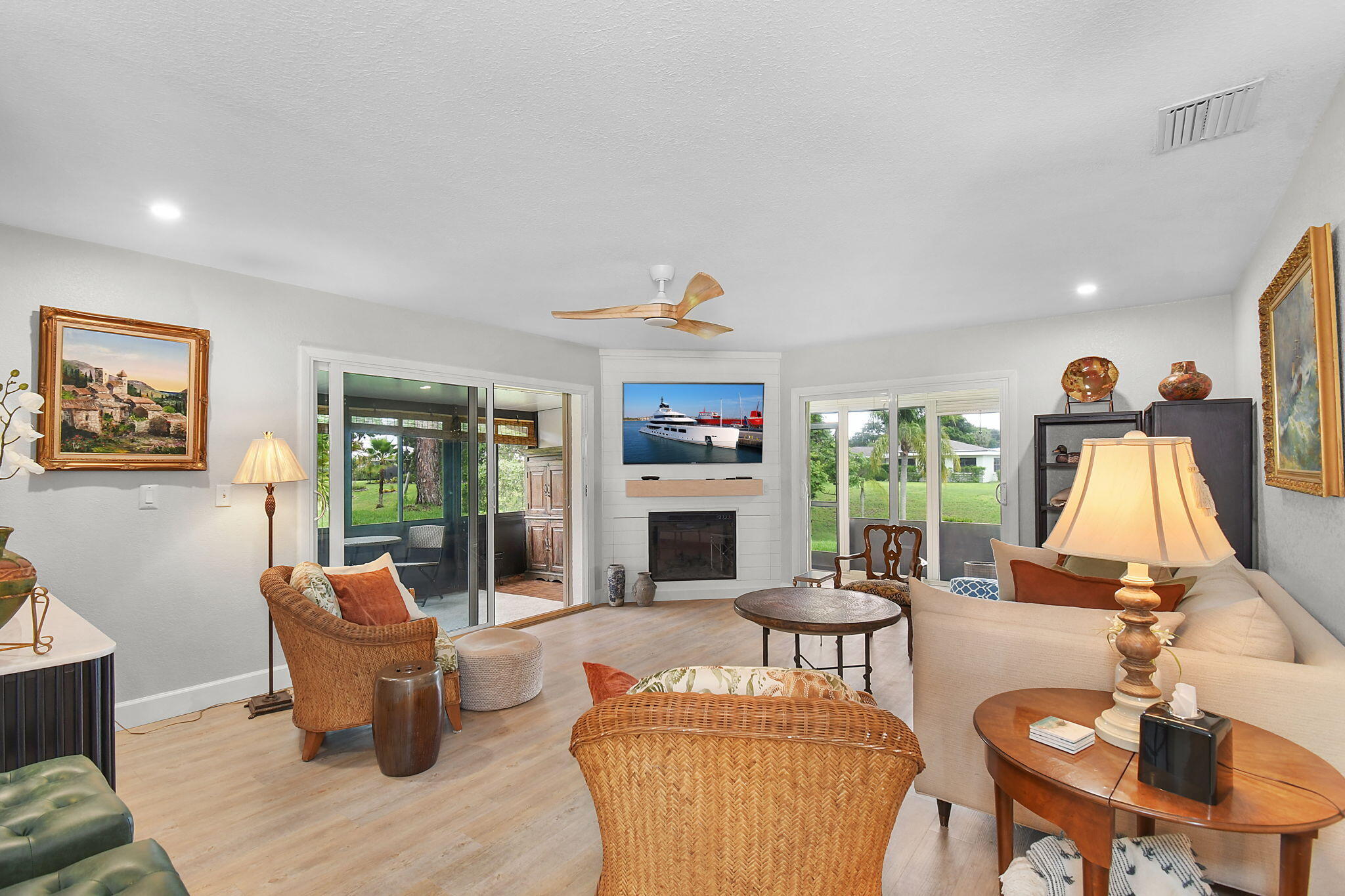 5251 Southeast Sea Island Way Stuart, FL 34997 - Photo 14 of 68 a living room with furniture a fireplace and a large window