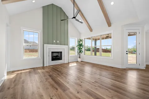 a kitchen with stainless steel appliances granite countertop a stove a sink a kitchen island a refrigerator a stove and a wooden floors