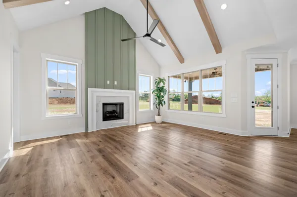 a kitchen with stainless steel appliances granite countertop a stove a sink a kitchen island a refrigerator a stove and a wooden floors
