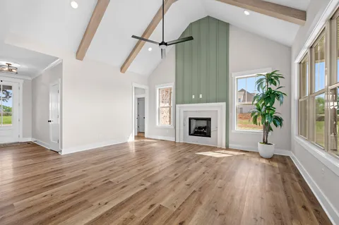 a view of a kitchen area with furniture and wooden floor