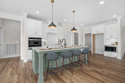 a kitchen with sink a stove and cabinets
