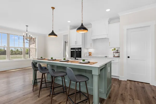 a kitchen with sink and stove top oven