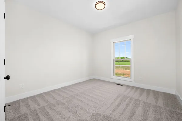 a view of room with window and wooden floor