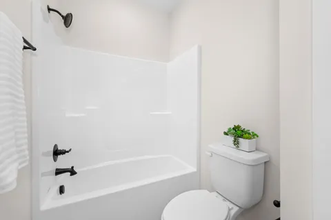 a bathroom with a double vanity sink toilet and shower