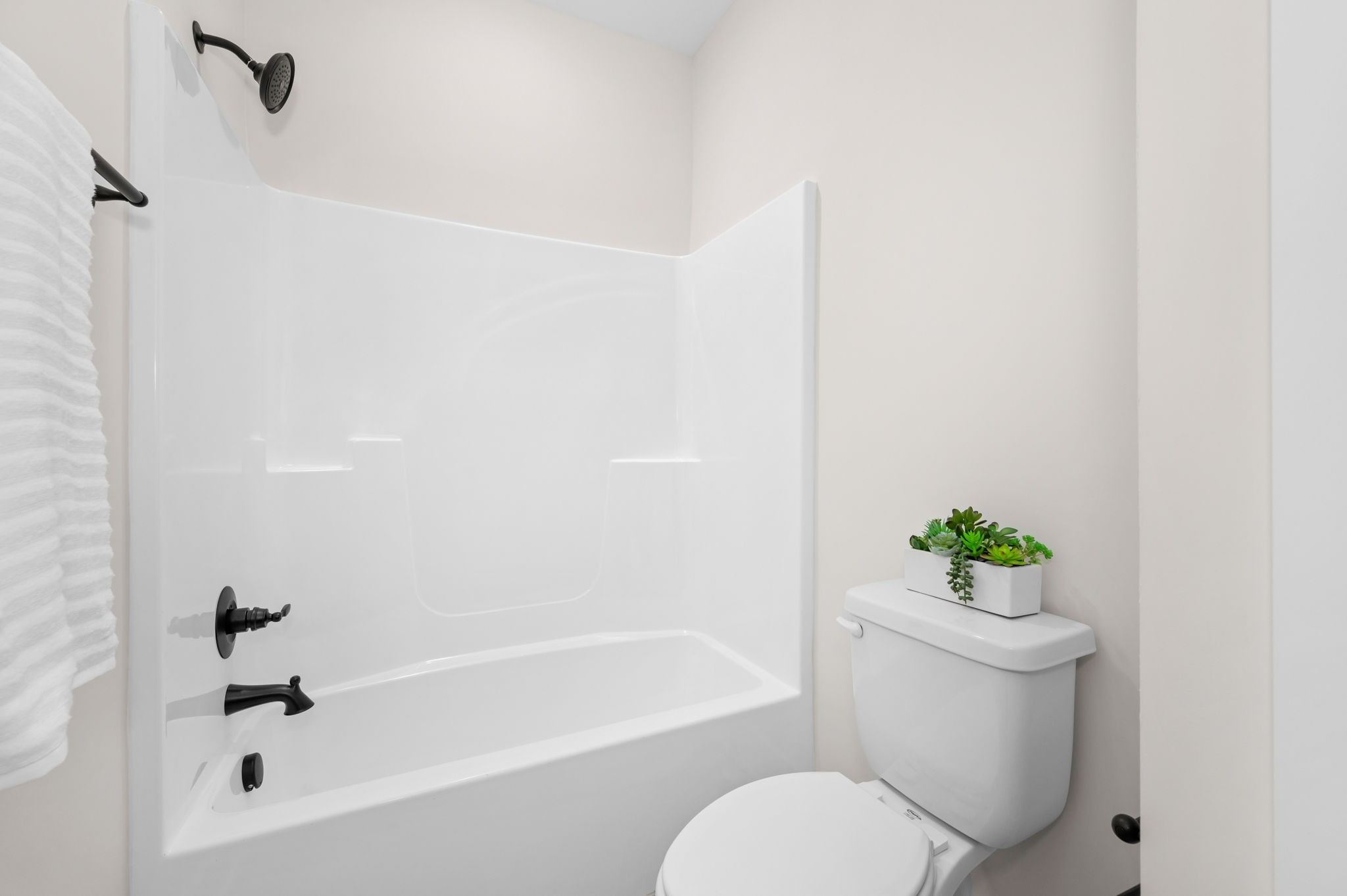 7254 West Gum Road Murfreesboro, TN 37127 - Photo 22 of 58 a white toilet sitting next to a bath tub