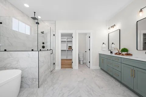 a spacious bathroom with a double vanity sink mirror and a