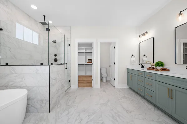 a spacious bathroom with a double vanity sink mirror and a