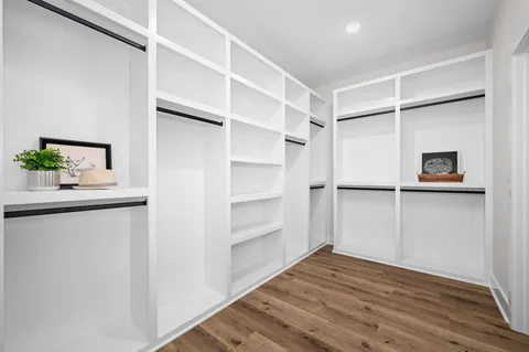 a view of a room with wooden floor and bathroom